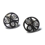 A PAIR OF 18CT WHITE GOLD AND DIAMOND STUD EARRINGS Having three diamonds in a pierced spherical