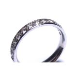 AN 18CT WHITE GOLD AND DIAMOND HALF ETERNITY RING Having a single row of round cut diamonds (size