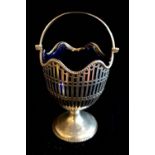 AN EARLY 20TH CENTURY SILVER AND BLUE GLASS BON BON BASKET Classical form with swing handle, pierced