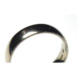 AN 18CT WHITE GOLD AND DIAMOND GENT'S WEDDING BAND The wide band set with a single diamond (size T/
