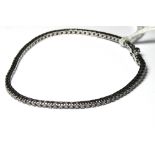 AN 18CT WHITE GOLD AND DIAMOND TENNIS BRACELET Single row of round cut diamonds. (approx 18cm)