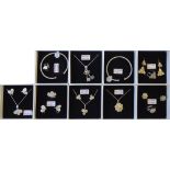 A COLLECTION OF EIGHT CASED SILVER JEWELLERY Including necklace and earring suites and two slave