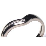 AN 18CT WHITE GOLD AND DIAMOND WEDDING BAND Having a single row of diamonds in a 'V' form mount (