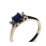 AN 18CT GOLD, SAPPHIRE AND DIAMOND THREE STONE RING Having an emerald cut sapphire flanked by