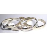 ELEVEN SILVER .925 BANGLES Along with one silver gilt.