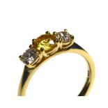 AN 18CT GOLD, YELLOW SAPPHIRE AND DIAMOND THREE STONE RING Having a round cut sapphire flanked by