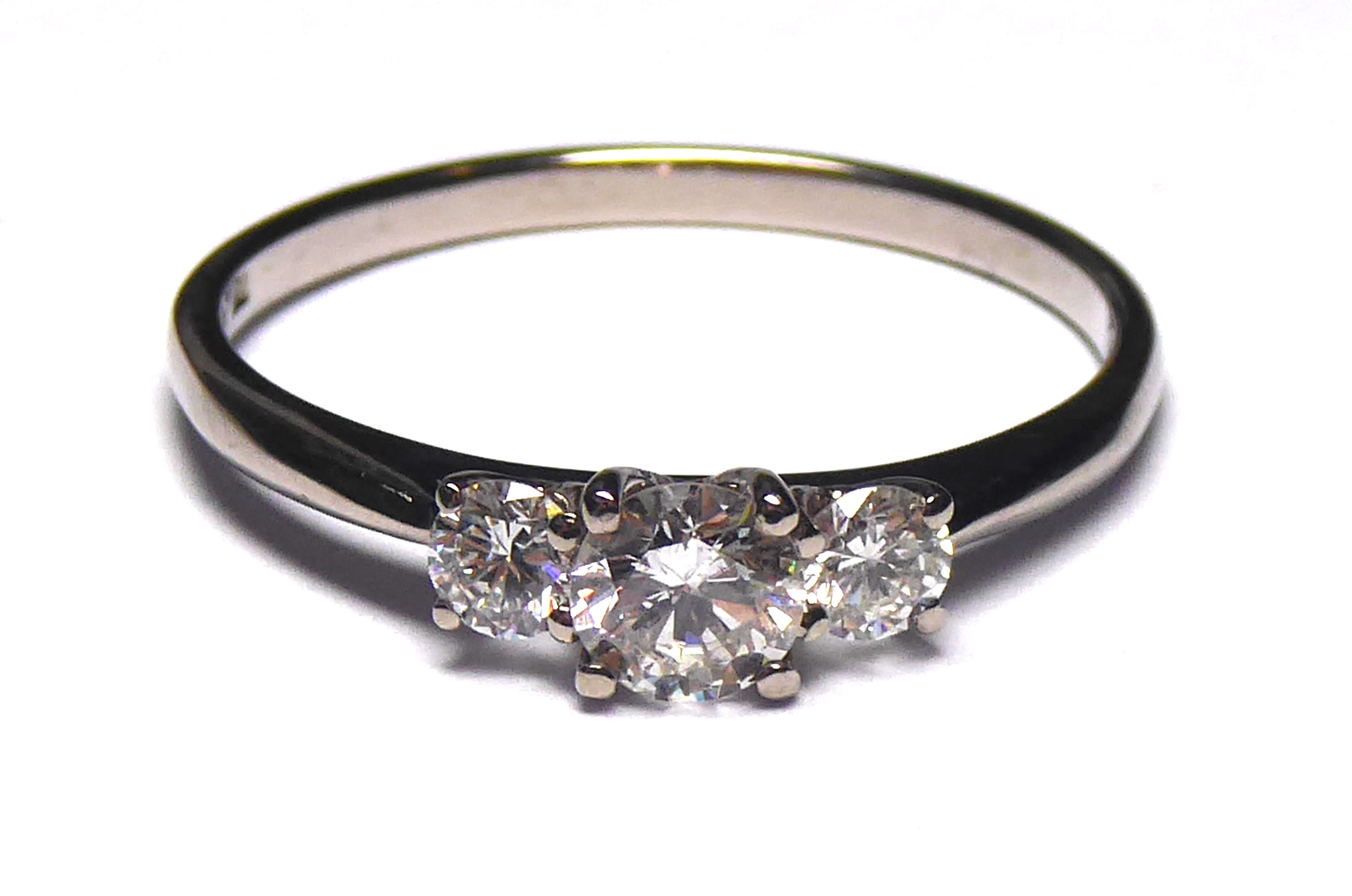 AN 18CT WHITE GOLD AND DIAMOND THREE STONE RING Having an arrangement of graduating round cut - Image 2 of 2