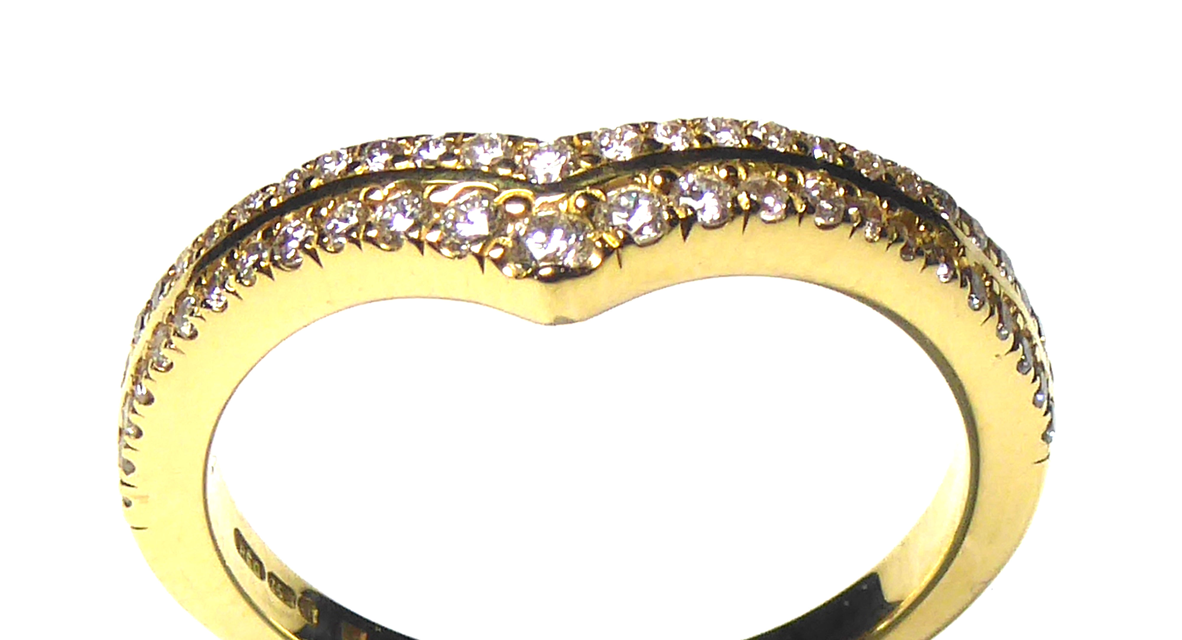 AN 18CT GOLD AND DIAMOND HALF ETERNITY RING Having two rows of round cut diamonds (size K/L).