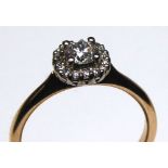 AN 18CT ROSE GOLD AND ROUND BRILLIANT CUT DIAMOND HALO RING Complete with IGI certificate. (