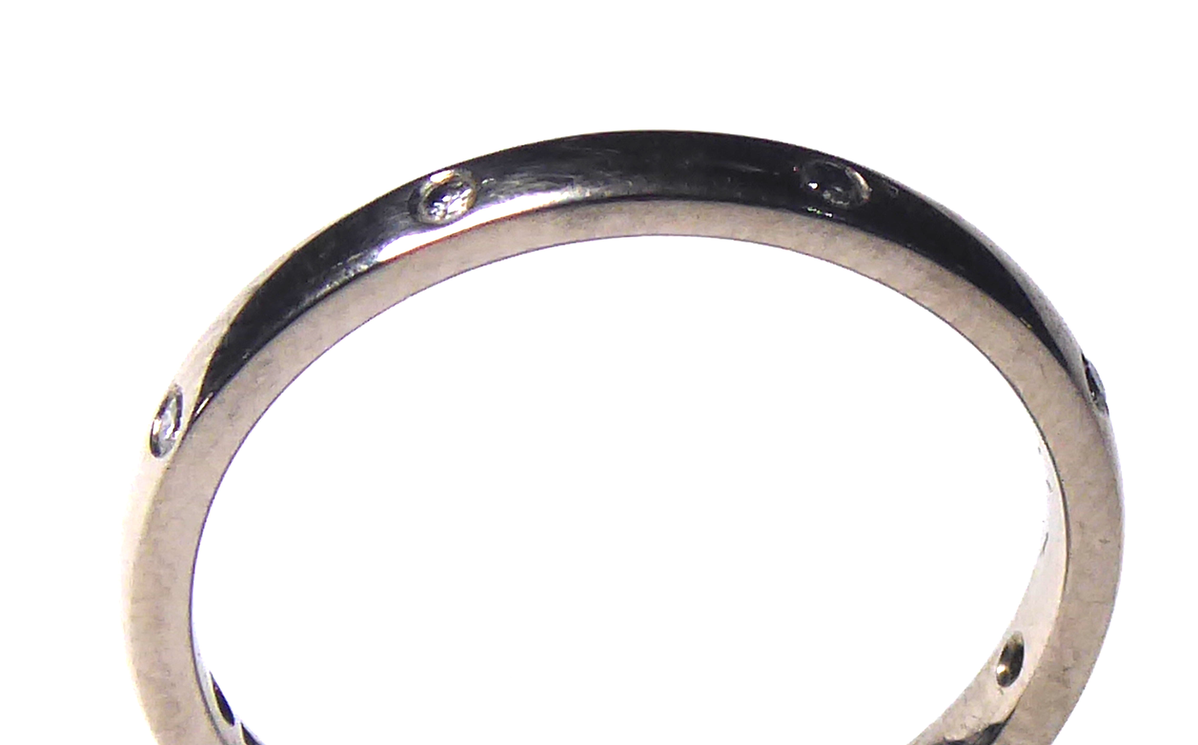 AN 18CT WHITE GOLD AND DIAMOND SET ETERNITY RING Plain form set with round cut diamonds (size L/M).