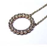 A 9CT GOLD AND DIAMOND PENDANT NECKLACE Having a single row of round cut diamonds in a spherical
