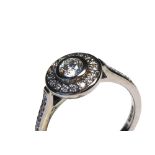 AN 18CT WHITE GOLD AND ROUND BRILLIANT CUT DIAMOND HALO RING The central diamond surrounded by a