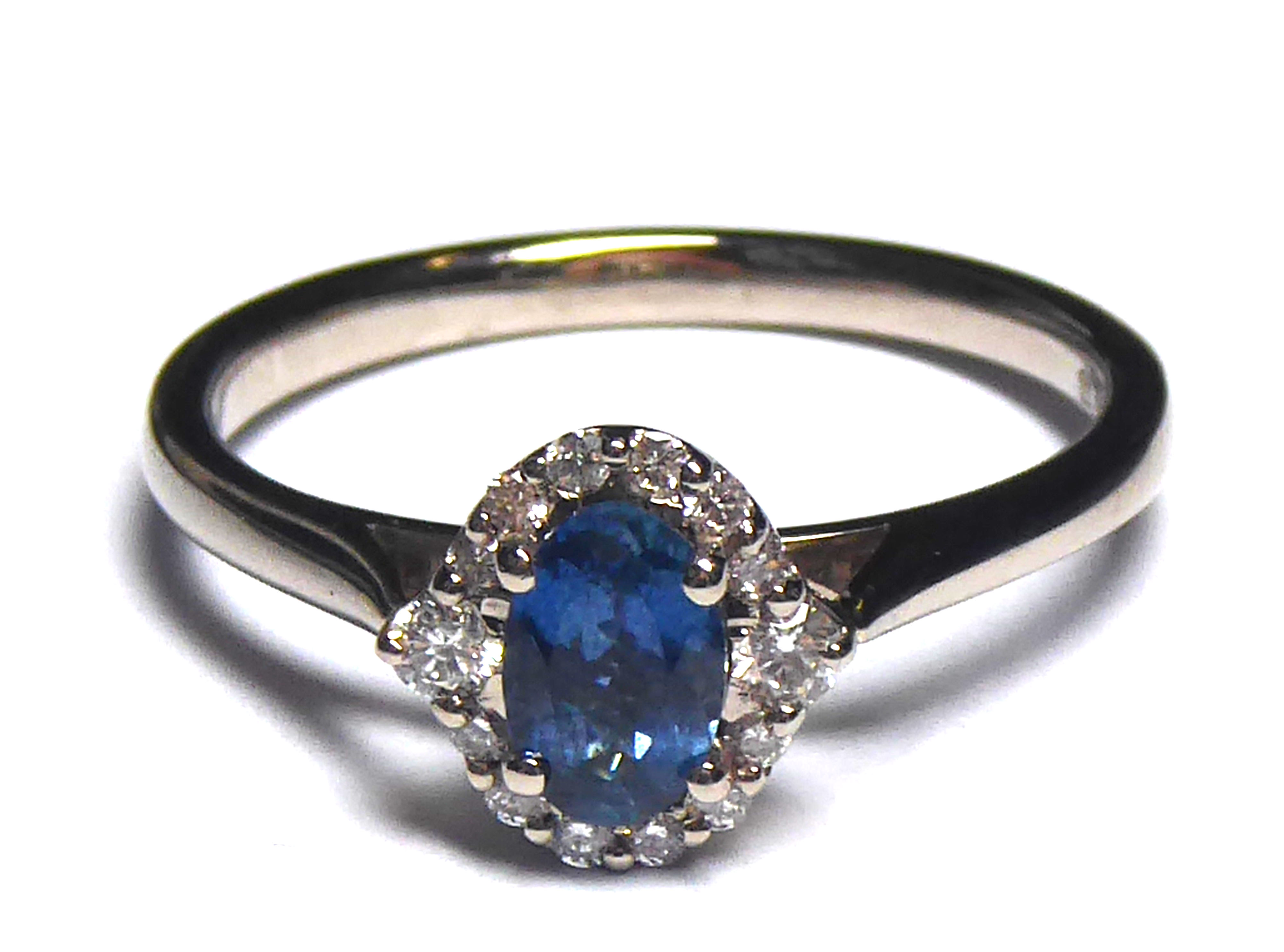 AN 18CT GOLD, WHITE SAPPHIRE AND DIAMOND RING Having an oval cut sapphire edged with diamonds ( - Image 2 of 2
