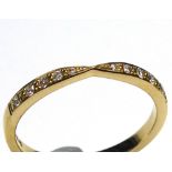 AN 18CT GOLD AND DIAMOND WEDDING BAND Having two rows of round cut diamonds (size M/N).