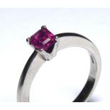 A WHITE GOLD AND PINK SAPPHIRE SOLITAIRE RING Having a single cushion cut sapphire on ?V? form