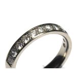 AN 18CT WHITE GOLD AND DIAMOND HALF ETERNITY RING Having a single row of round cut diamonds (size