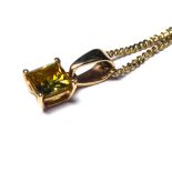 A 9CT GOLD AND YELLOW SAPPHIRE PENDANT The Princess cut stone and fine link chain. (approx 0.4cm x