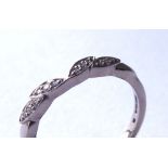 AN 18CT GOLD AND DIAMOND HALF ETERNITY RING Having two rows of diamonds forming a leaf design (