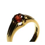 A VINTAGE 18CT GOLD AND GARNET GENT'S SIGNET RING Set with a single round cut stone (size P).