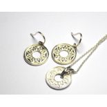A COLLECTION OF SILVER PENDANT NECKLACES Each having a pierced spherical disc and fine link chain,