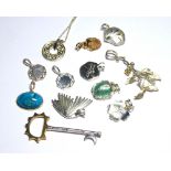 A COLLECTION OF SILVER GILT AND TURQUOISE CHARMS Each set with an oval cabochon cut stone,
