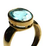 A 9CT GOLD AND AQUAMARINE GENT'S SIGNET RING Having a single oval cut stone in a raised mount (