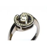 AN 18CT WHITE GOLD AND ROUND BRILLIANT CUT DIAMOND HALO RING The central diamond surrounded by a