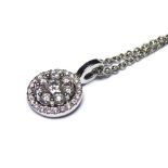 AN 18CT WHITE GOLD AND DIAMOND PENDANT NECKLACE The arrangement of round cut diamonds in a cluster