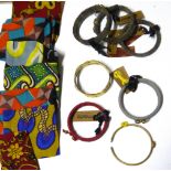 A COLLECTION OF KENYAN COSTUME JEWELLERY To include white metal loop earrings, bangles and cloth