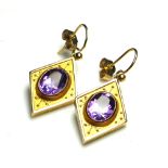 A PAIR OF 9CT GOLD AND AMETHYST EARRINGS Each set with an oval stone in a lozenge form mount. (