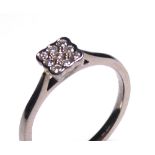 AN 18CT WHITE GOLD AND DIAMOND RING Having an arrangement of round cut diamonds (size L).