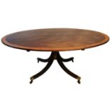 A LARGE REGENCY DESIGN OVAL MAHOGANY AND AMBOYNA BANDED OVAL DINING TABLE Raised on a turned