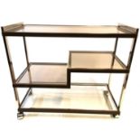 A STYLISH VINTAGE ITALIAN CHROME AND BRASS TROLLEY With smoked glass shelves. (83cm x 40cm x 73cm)