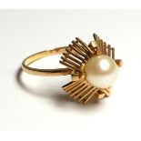 A VINTAGE YELLOW METAL AND PEARL RING Having a single pearl set in a geometric form mount (size S).