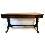 A VICTORIAN ROSEWOOD LIBRARY TABLE With two drawers, raised on turned columns with acanthus carved