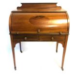 AN EDWARDIAN MAHOGANY CYLINDER BUREAU With fitted interior, cantilever writing surface above two