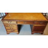 A REGENCY STYLE MAHOGANY PARTNER'S DESK With tan leather surface above an arrangement of drawers and
