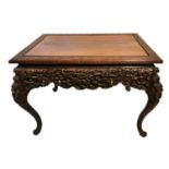 A 19TH CENTURY CHINESE HARDWOOD CENTRE TABLE The rectangular top above a heavily carved apron, on