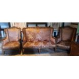 AN EARLY 20TH CENTURY FRENCH WALNUT FRAMED THREE PIECE SUITE Upholstered in a peach floral fabric.