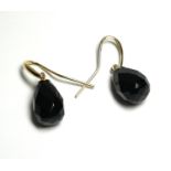 A VINTAGE PAIR OF 9CT GOLD AND ONYX EARRINGS Each set with a faceted pear cut some drop. (onyx