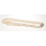 A PEARL NECKLACE With three strings of graduated pearls measuring 6.8 to 9.7mm on a white gold