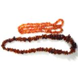 A VINTAGE AMBER NECKLACE Having a single row of graduating amber shards, together with a similar