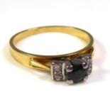 AN 18CT GOLD, SAPPHIRE AND DIAMOND RING The single round cut sapphire flanked by two pairs of