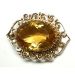 A 14CT GOLD AND CITRINE PENDANT The oval cut citrine with scrolled gold mount (citrine approx 3.