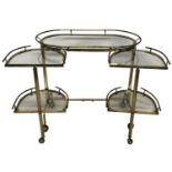 A STYLISH MID 20TH CENTURY BRASS AND GLASS DRINKS TROLLEY The oval top with gallery rails above