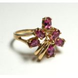 A 9CT GOLD AND PINK TOURMALINE CLUSTER RING Having an arrangement of oval cut stones (size Q).