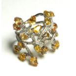 A WHITE METAL, YELLOW SAPPHIRE AND DIAMOND WIDE BAND RING The arrangement of pear cut sapphires