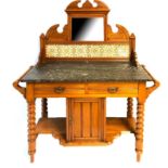 AN EDWARDIAN SATIN WALNUT WASH STAND With mirror and tiled back, black marble top above two