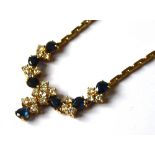 AN 18CT GOLD, SAPPHIRE AND DIAMOND NECKLACE Having an arrangement of tear firm sapphires