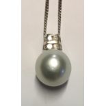 AN 18CT WHITE GOLD, DIAMOND AND PEARL PENDANT The single pearl set with two rows of diamonds, on a